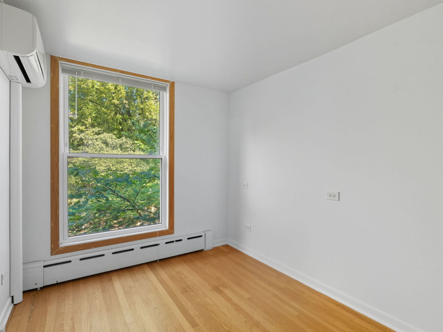 1412 East Rochdale Place Chicago, IL 60615 - Photo 11 of 21 a view of an empty room with wooden floor and a window