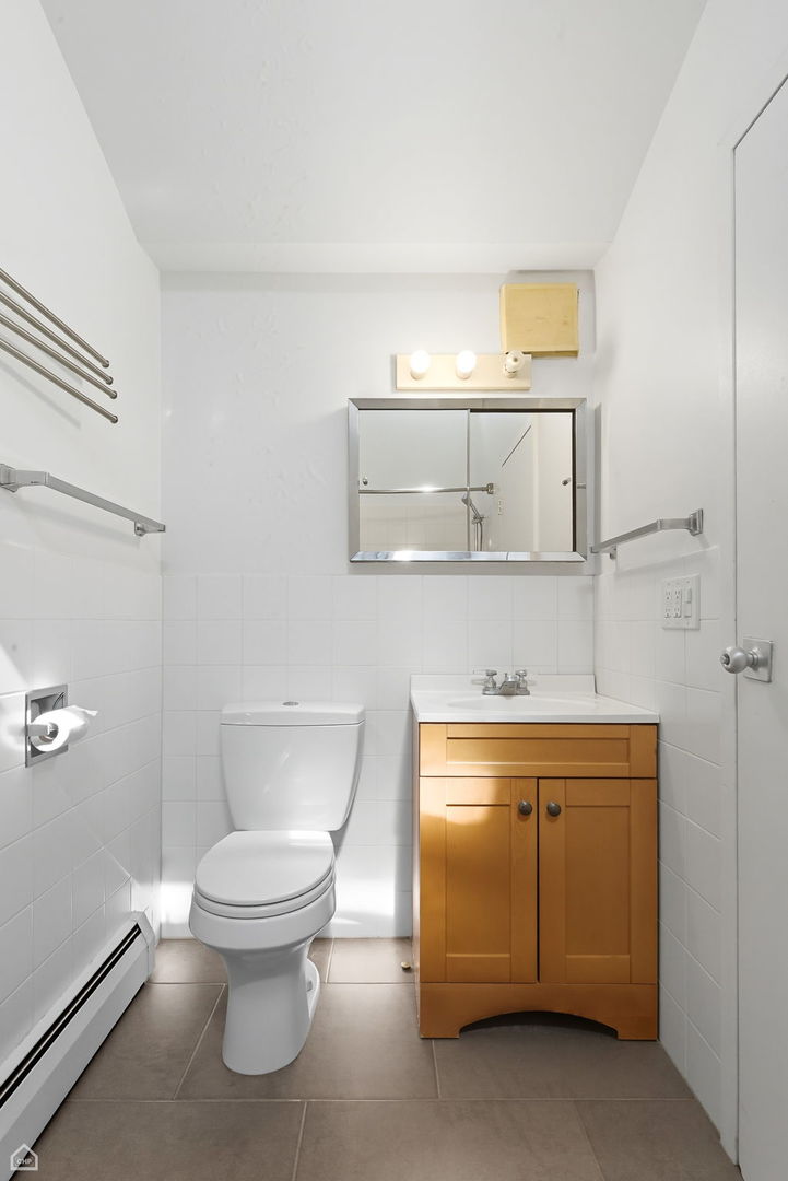 1412 East Rochdale Place Chicago, IL 60615 - Photo 12 of 21 a white toilet sitting next to a bathroom sink