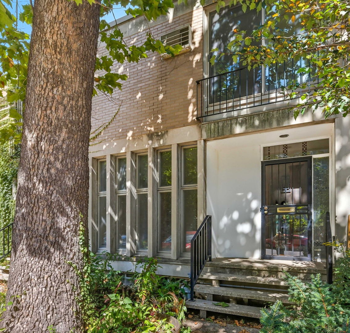 1412 East Rochdale Place Chicago, IL 60615 - Photo 3 of 21 a front view of a house with a garden