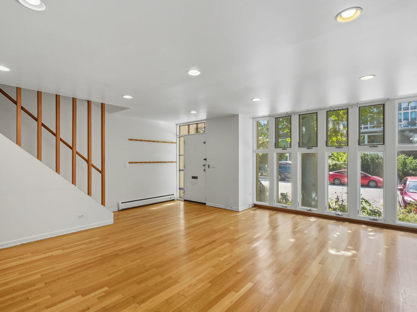 1412 East Rochdale Place Chicago, IL 60615 - Photo 4 of 21 a view of an empty room with wooden floor and windows