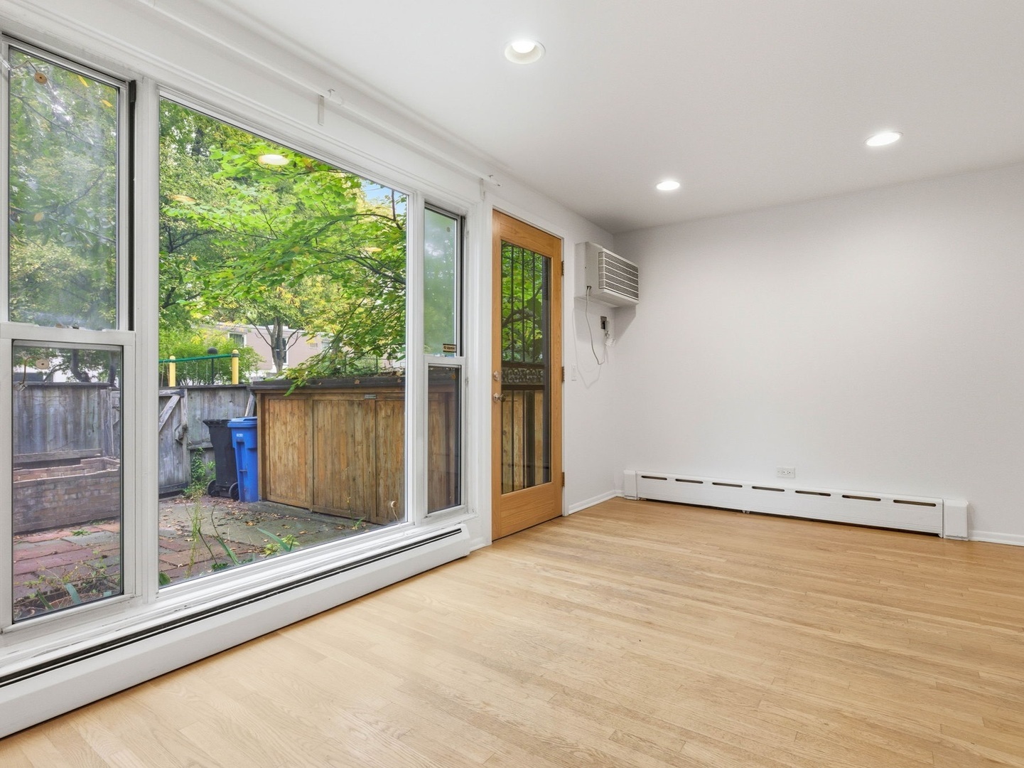 1412 East Rochdale Place Chicago, IL 60615 - Photo 8 of 21 a view of an empty room with wooden floor and a window