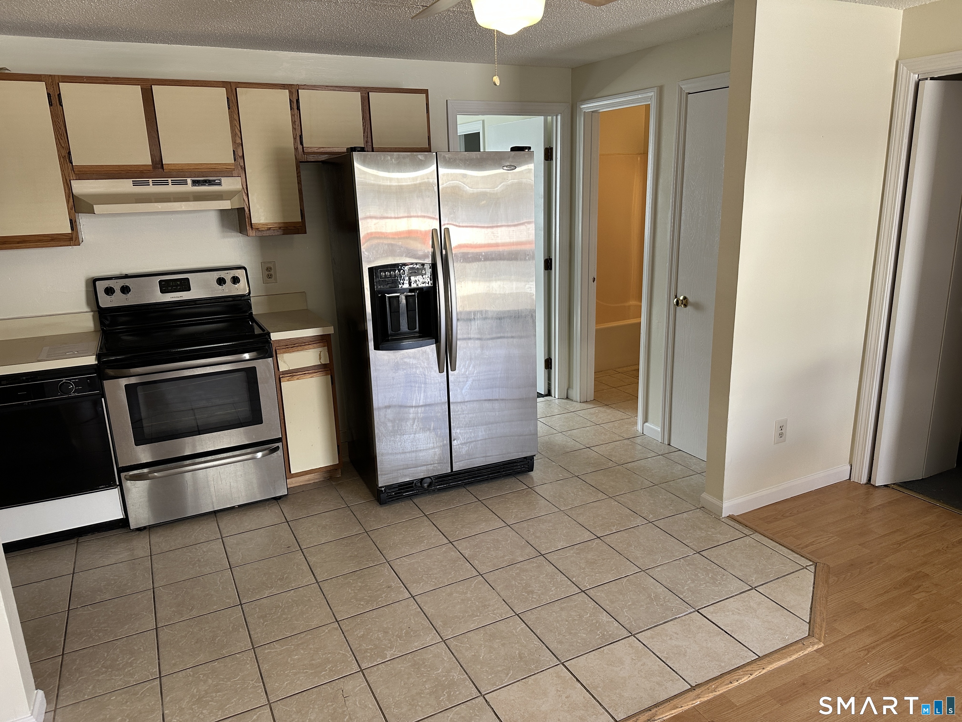 114 Bucks Hill Road, Unit 4 Waterbury, CT 06704 - Photo 6 of 12 a kitchen with stainless steel appliances a refrigerator and a stove top oven