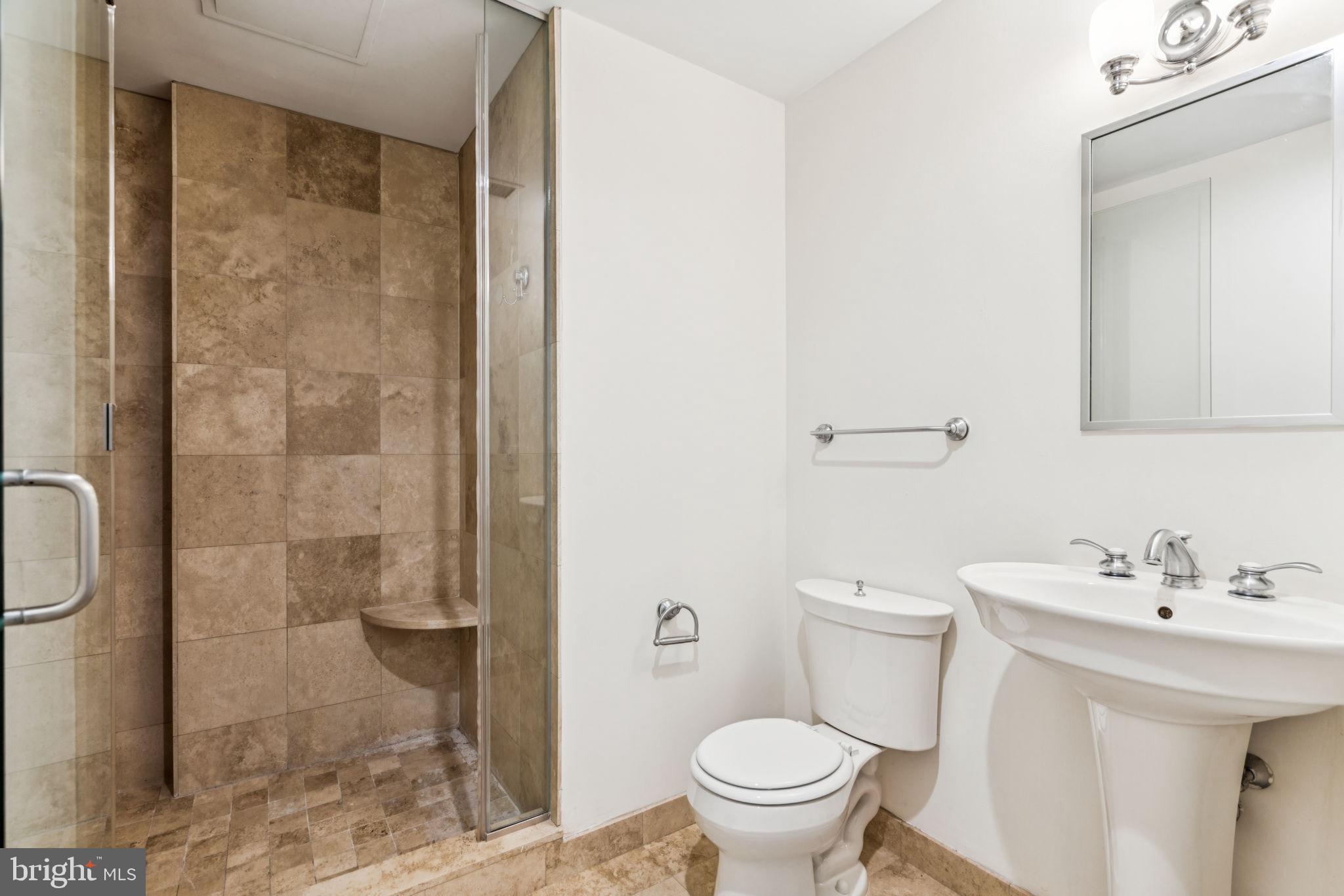 1701 Locust Street, Unit 2111 Philadelphia, PA 19103 - Photo 15 of 25 a bathroom with a sink a toilet and a shower