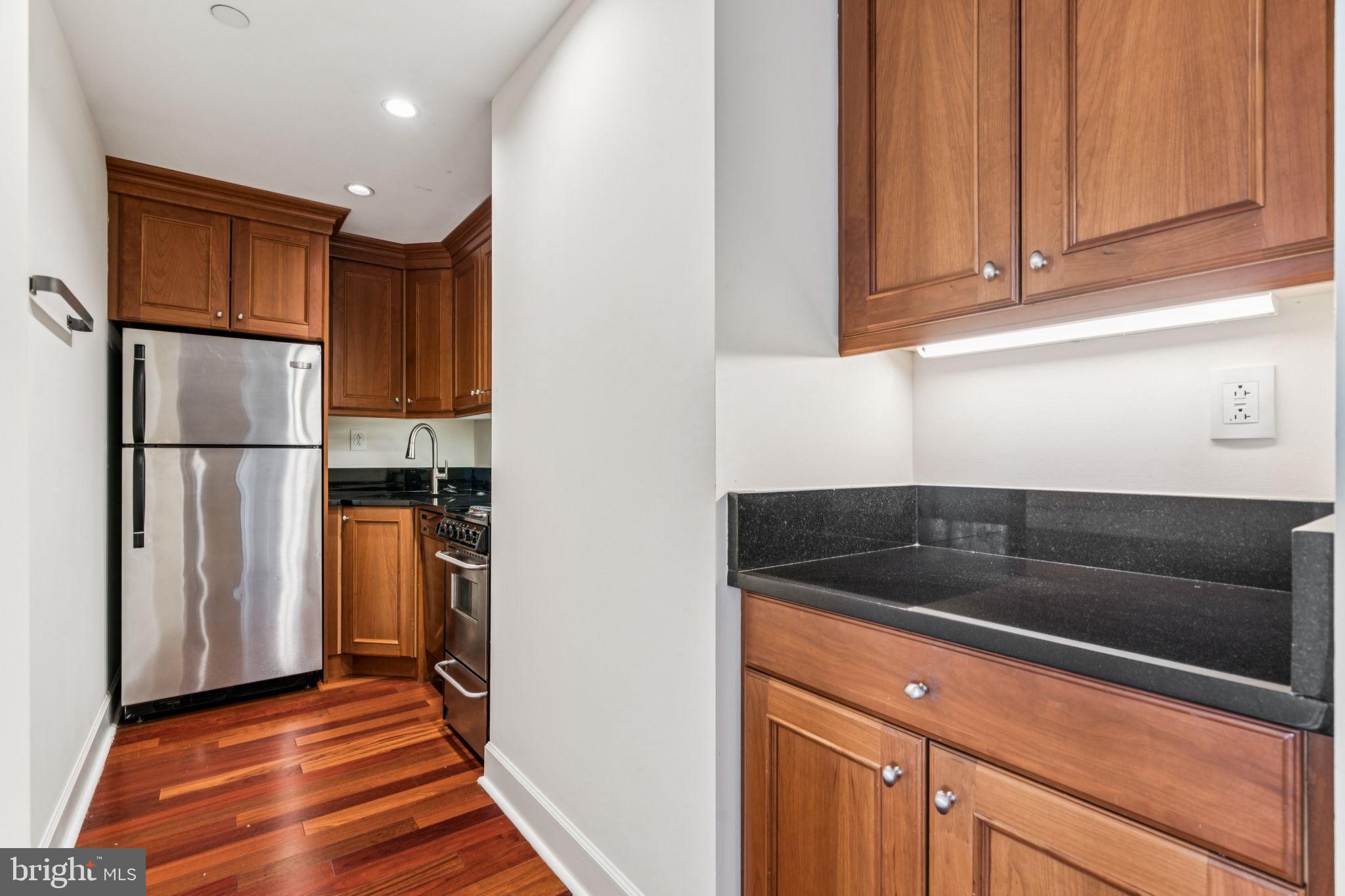 1701 Locust Street, Unit 2111 Philadelphia, PA 19103 - Photo 7 of 25 a kitchen with a refrigerator and a cabinets