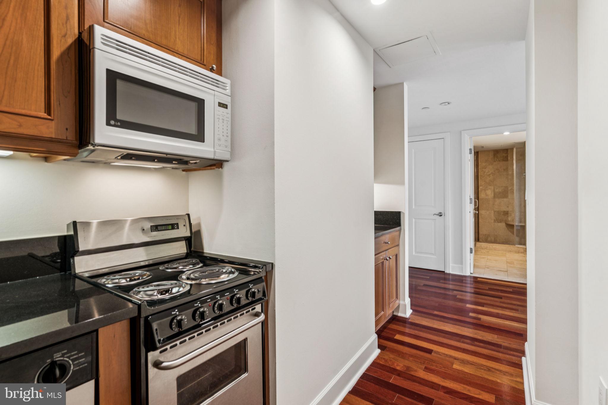 1701 Locust Street, Unit 2111 Philadelphia, PA 19103 - Photo 9 of 25 a kitchen with a stove and a microwave