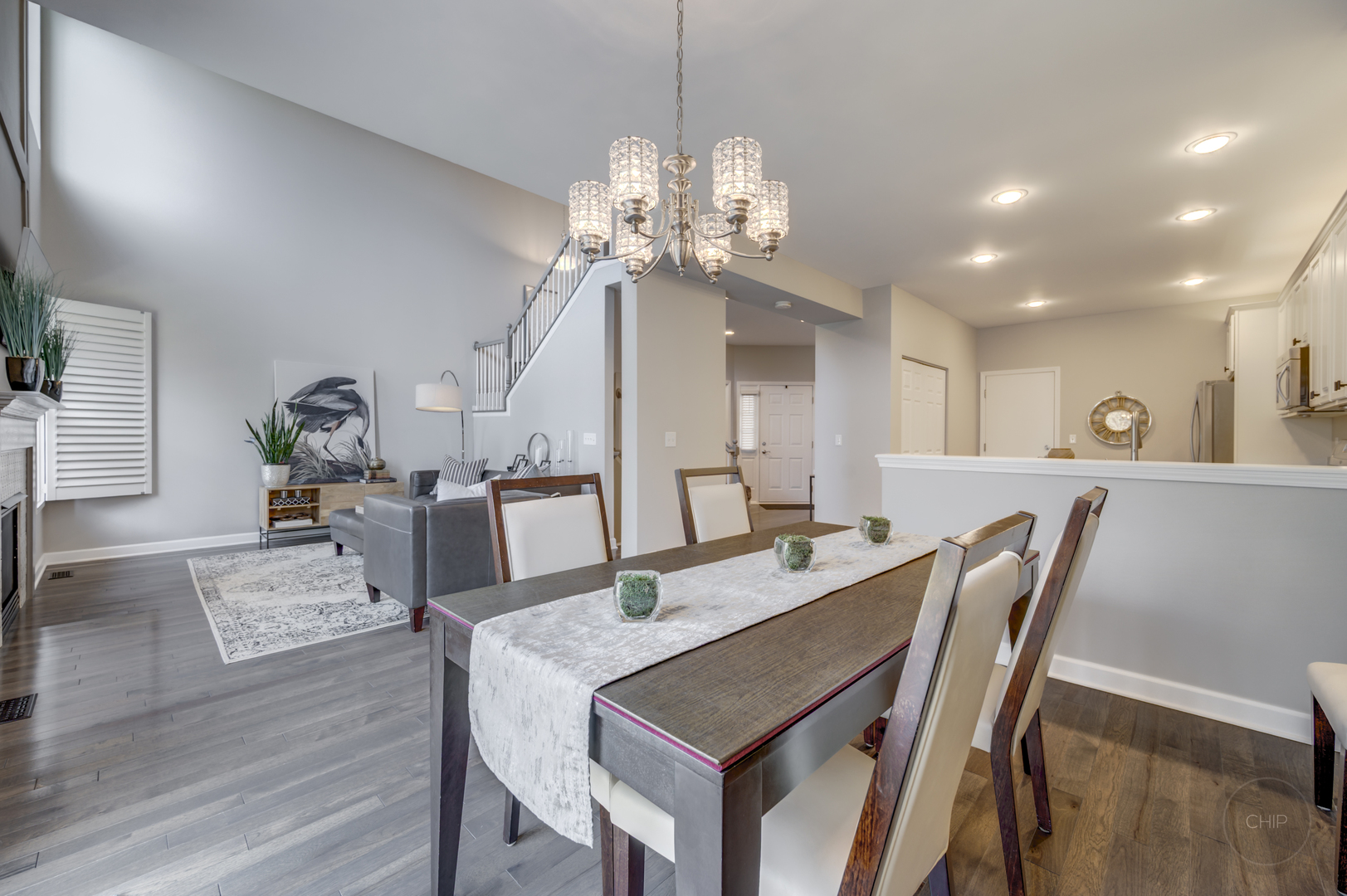 201 Dorset Avenue, Unit 201 Oswego, IL 60543 - Photo 15 of 41 a view of a dining room with furniture a chandelier and wooden floor