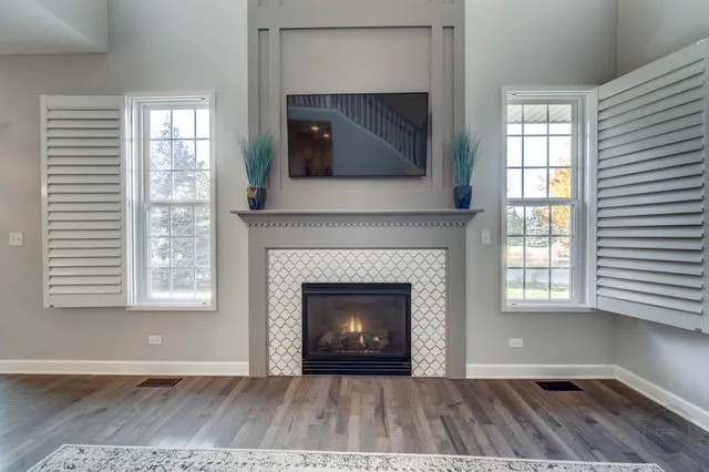 a living room with a fireplace and a flat screen tv