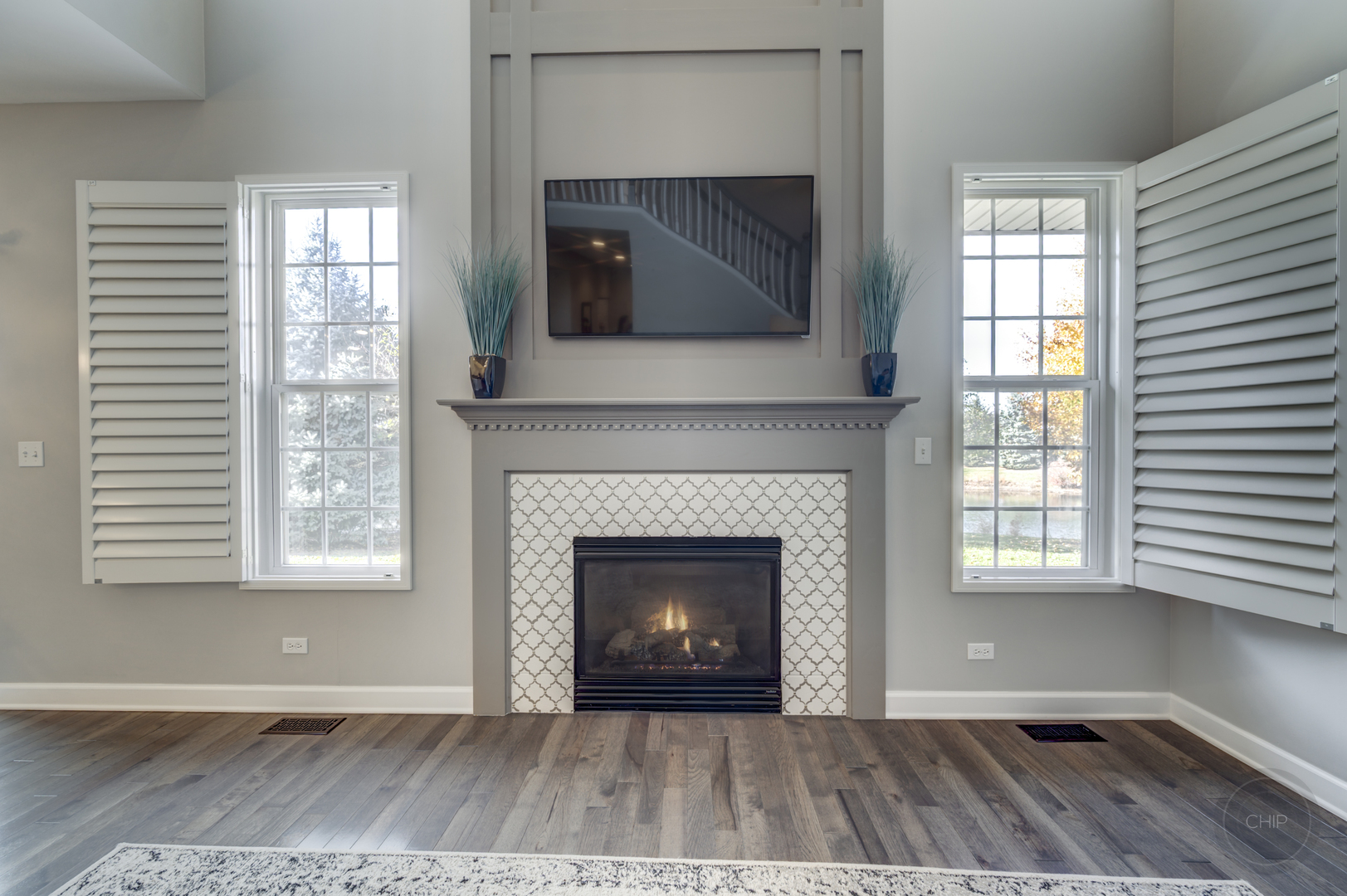 201 Dorset Avenue, Unit 201 Oswego, IL 60543 - Photo 20 of 41 a living room with a fireplace and a flat screen tv