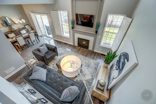 a living room with furniture a flat screen tv and a fireplace