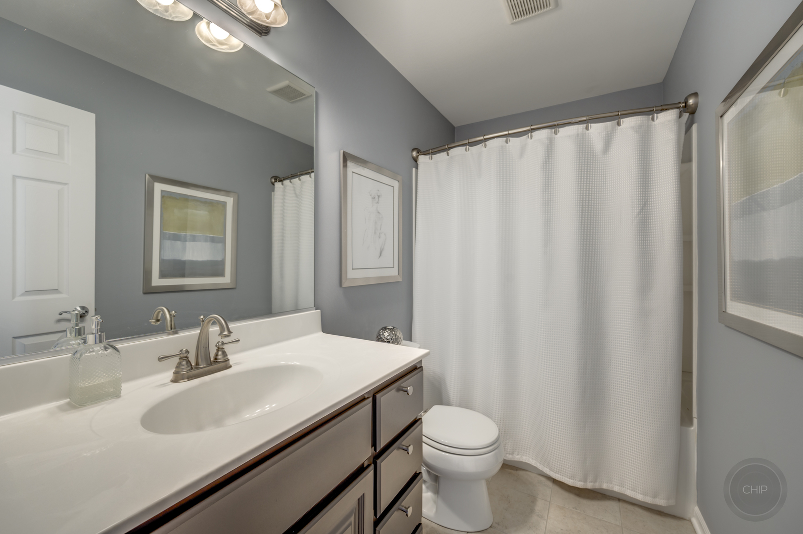 201 Dorset Avenue, Unit 201 Oswego, IL 60543 - Photo 27 of 41 a bathroom with a sink a toilet and a mirror