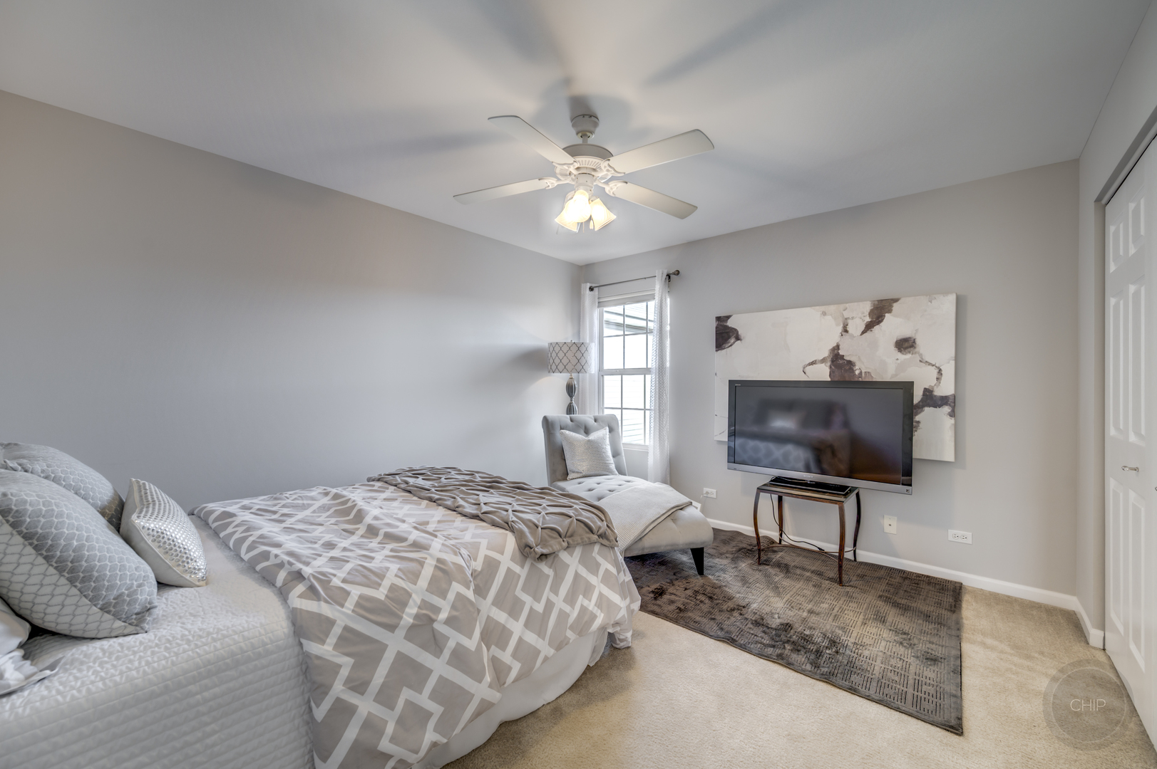 201 Dorset Avenue, Unit 201 Oswego, IL 60543 - Photo 29 of 41 a bedroom with a bed and a chandelier