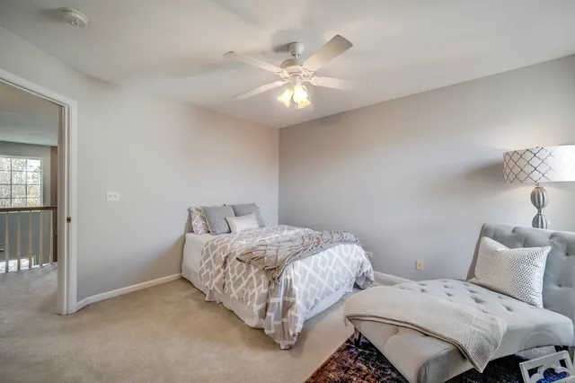 a spacious bedroom with a bed couch and a large window