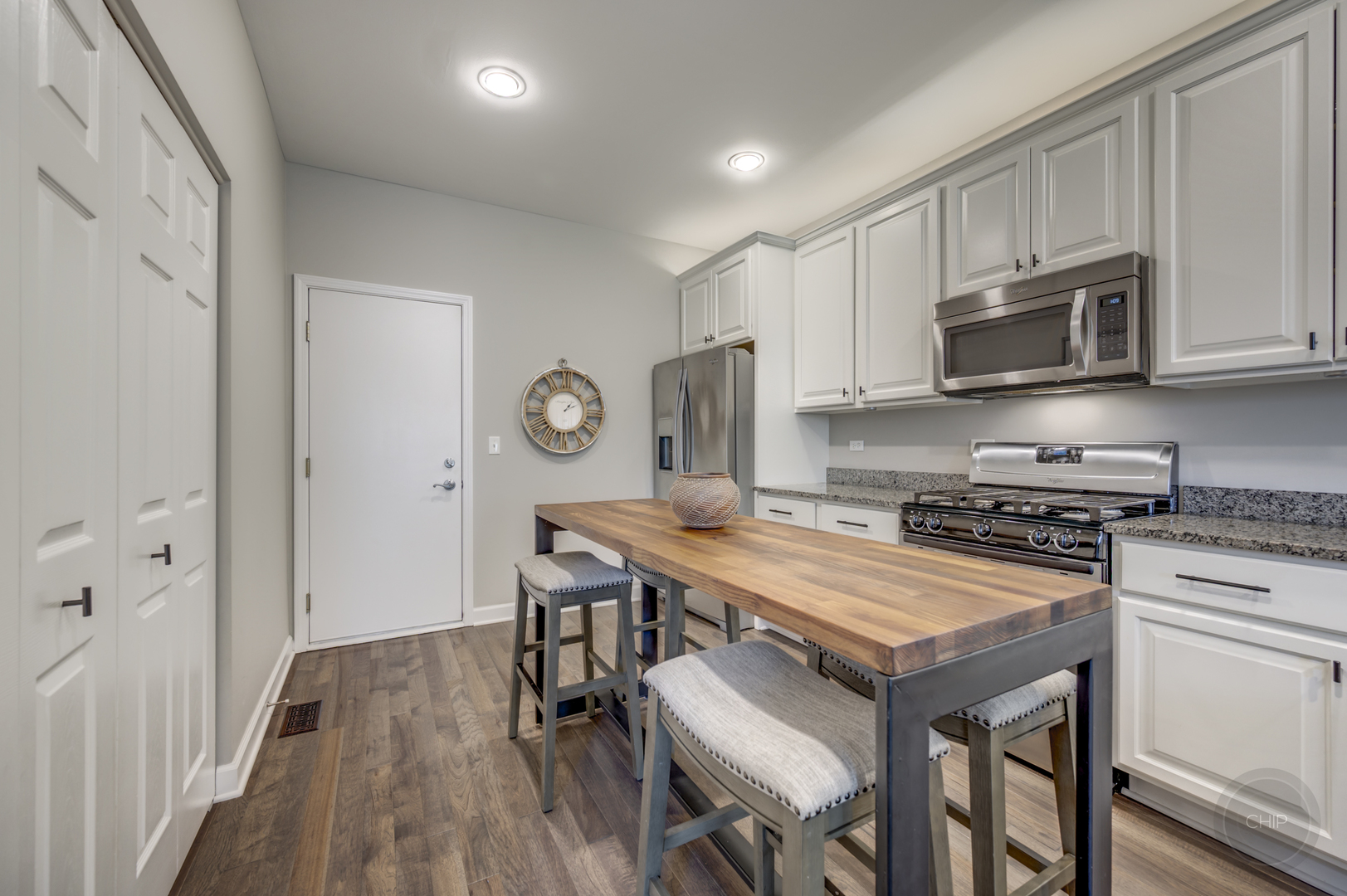 201 Dorset Avenue, Unit 201 Oswego, IL 60543 - Photo 8 of 41 a kitchen with stainless steel appliances a stove a sink island and a refrigerator