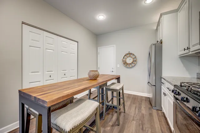 a room with a table chairs and a stove top oven