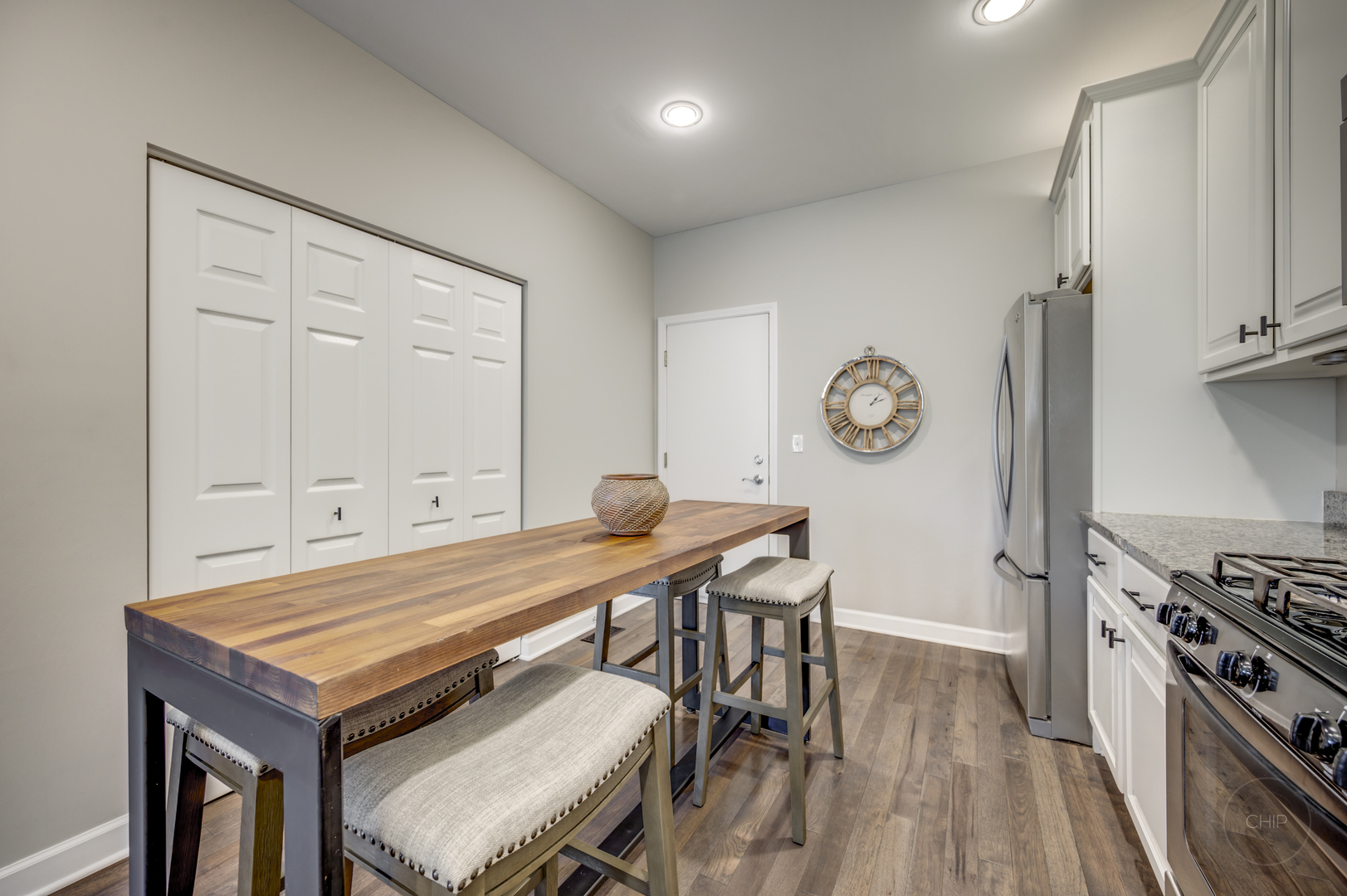 201 Dorset Avenue, Unit 201 Oswego, IL 60543 - Photo 10 of 41 a room with a table chairs and a stove top oven