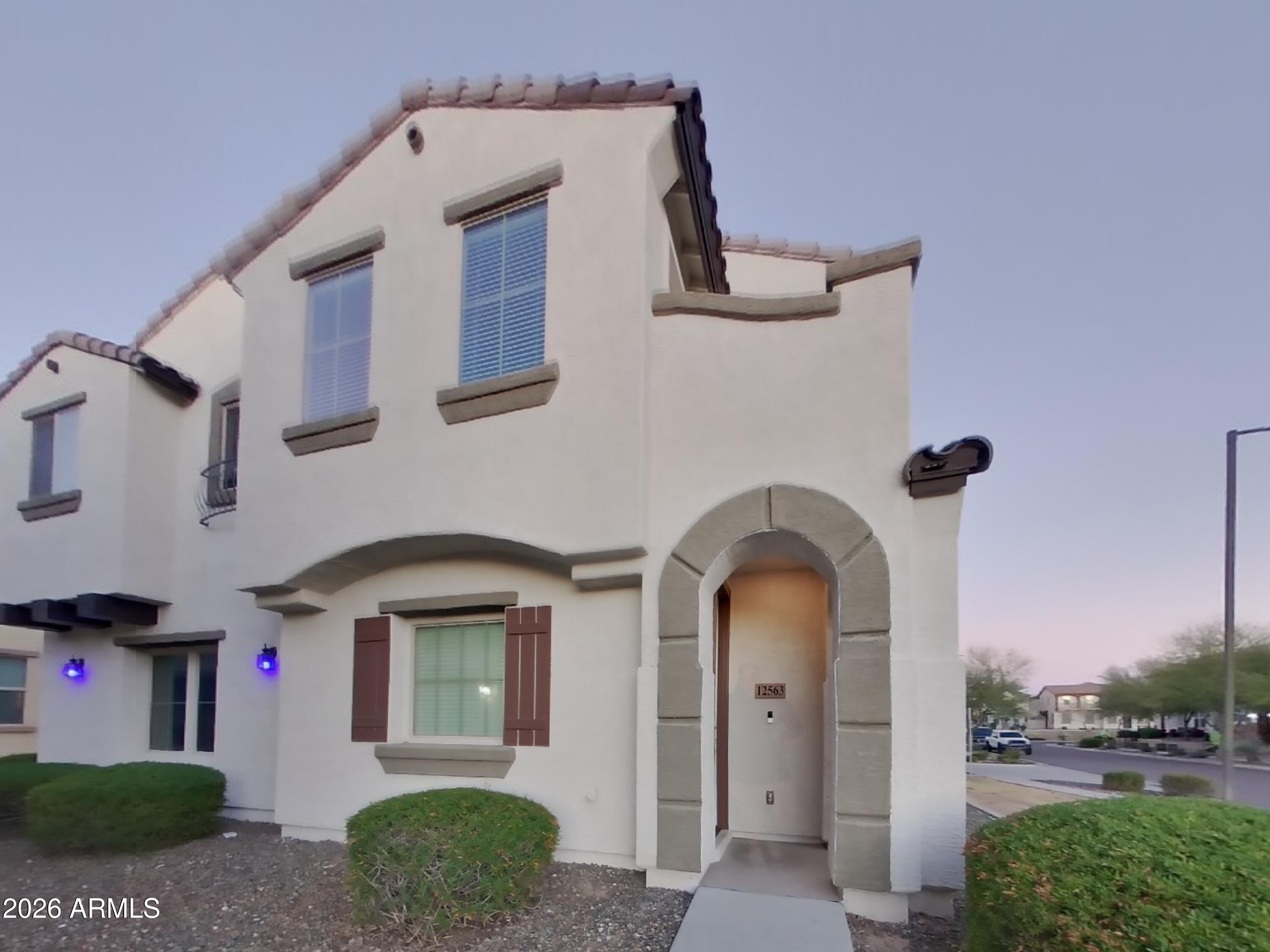 12563 West Gentle Rain Road Peoria, AZ 85383 - Photo 1 of 16 a front view of a house with a garden