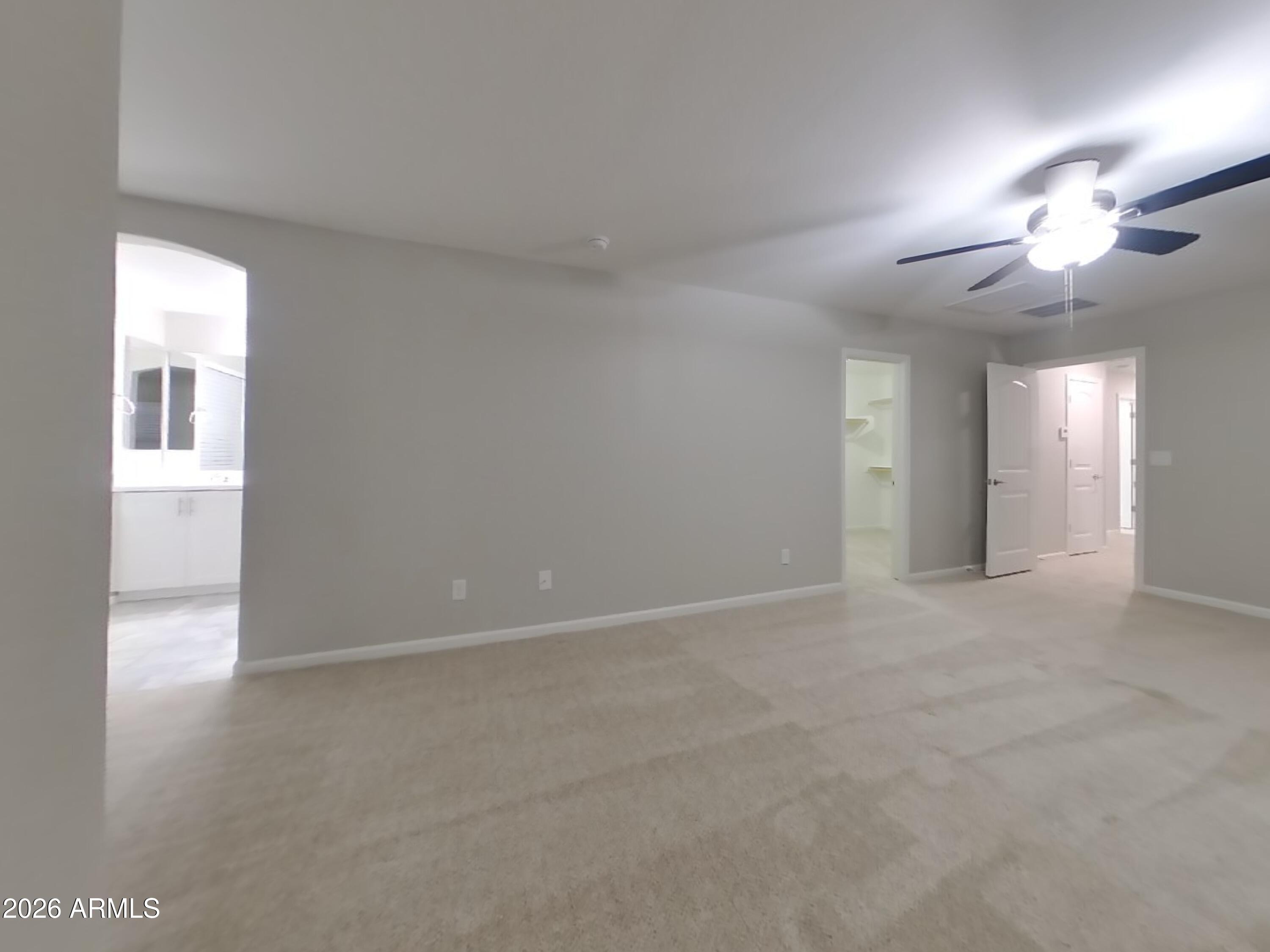 12563 West Gentle Rain Road Peoria, AZ 85383 - Photo 7 of 16 a view of an empty room with a chandelier fan