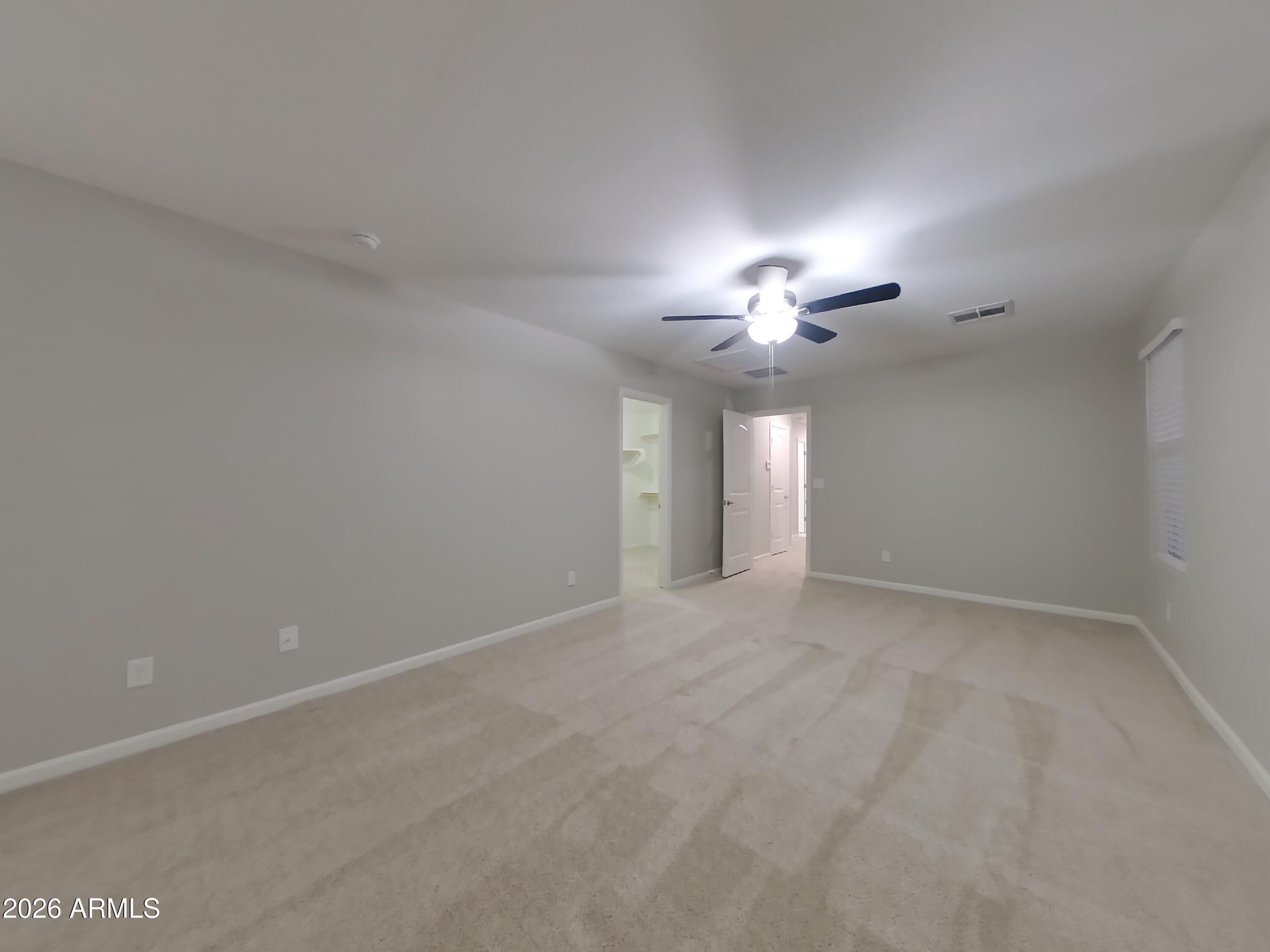 12563 West Gentle Rain Road Peoria, AZ 85383 - Photo 8 of 16 a view of an empty room with a chandelier fan