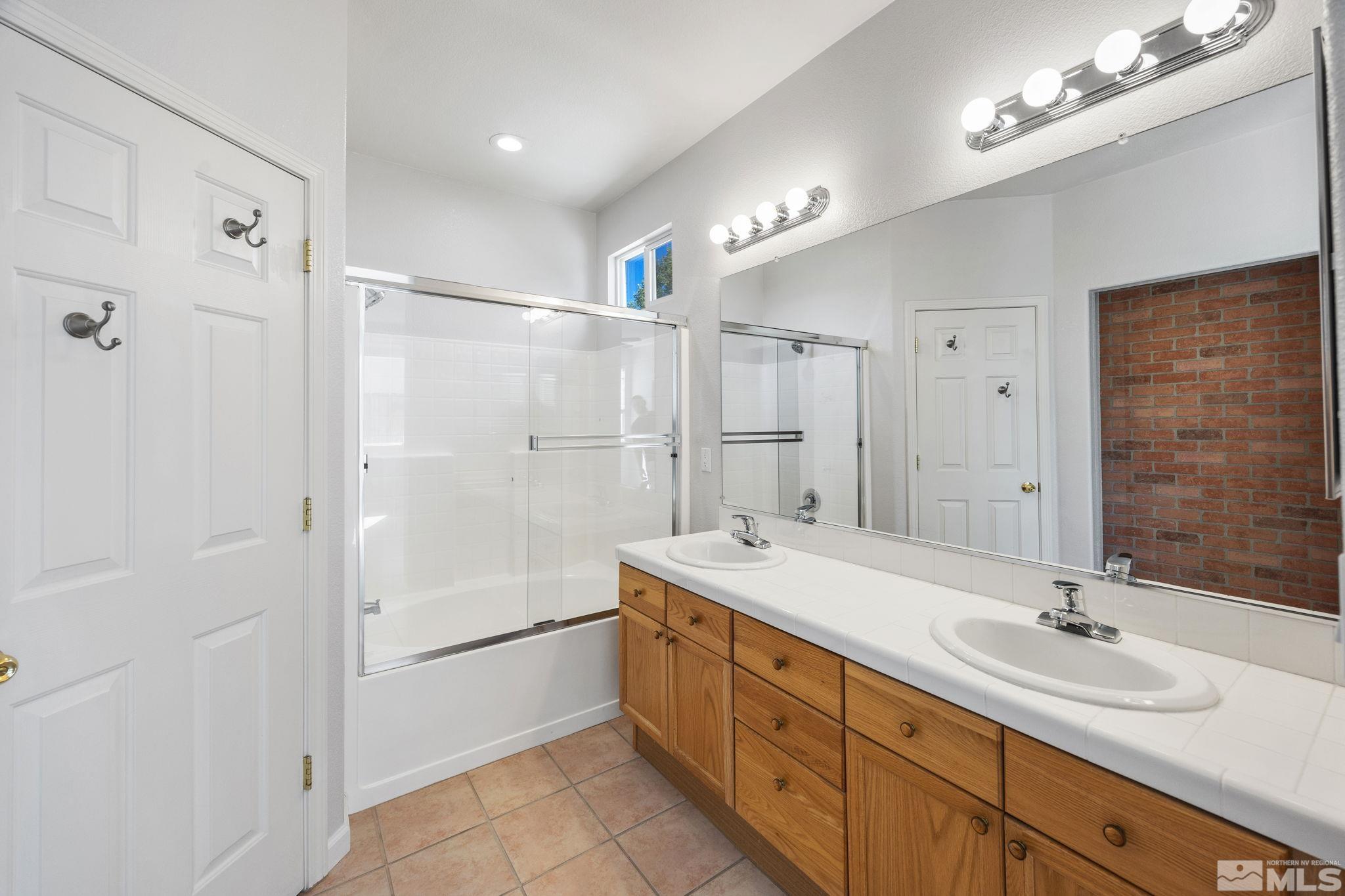 10600 Arbor Way Reno, NV 89521 - Photo 21 of 33 a spacious bathroom with a double vanity sink mirror double and shower