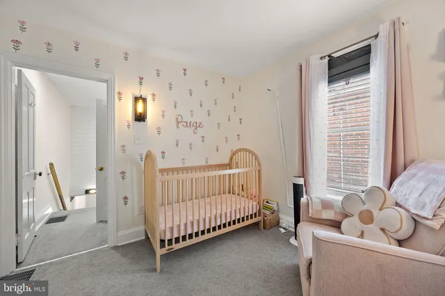 a view of a bedroom with furniture and windows