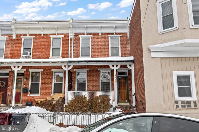 front view of a brick house with a large window