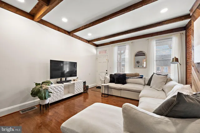 a living room with furniture and a flat screen tv