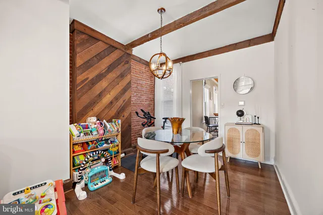 a dining room with furniture and wooden floor