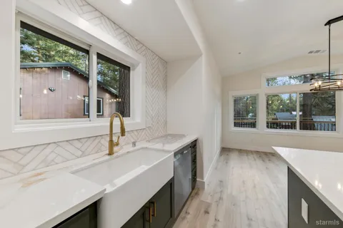 a kitchen with a sink and a large window