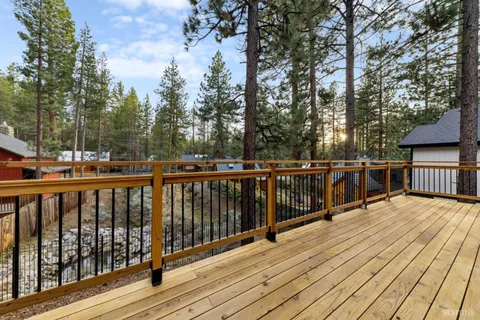 a view of deck with wooden floor and trees