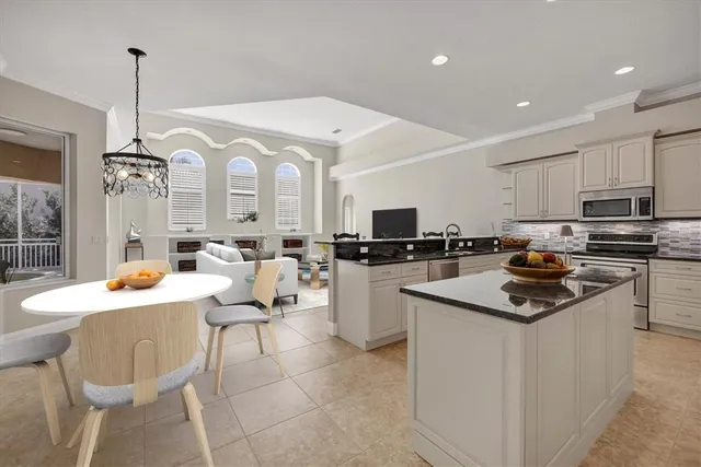 a kitchen with a sink stainless steel appliances and white cabinets