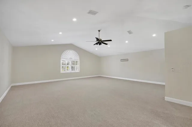 an empty room with a empty space and a ceiling fan