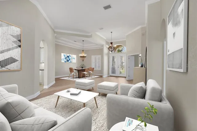 a living room with furniture and a chandelier