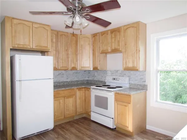 a kitchen with a stove a sink and a refrigerator