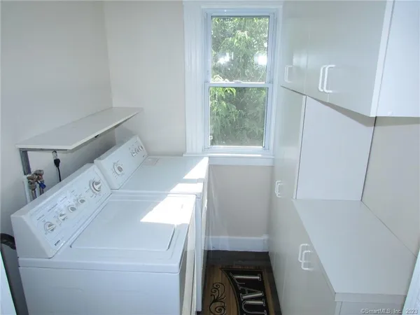 a view of staircase with railing and white walls