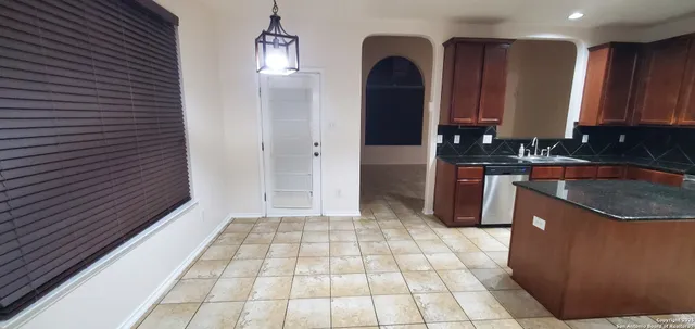 a kitchen with stainless steel appliances granite countertop a sink and a stove