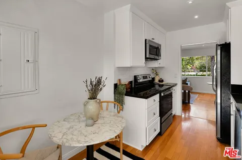 a kitchen with granite countertop a stove and a refrigerator
