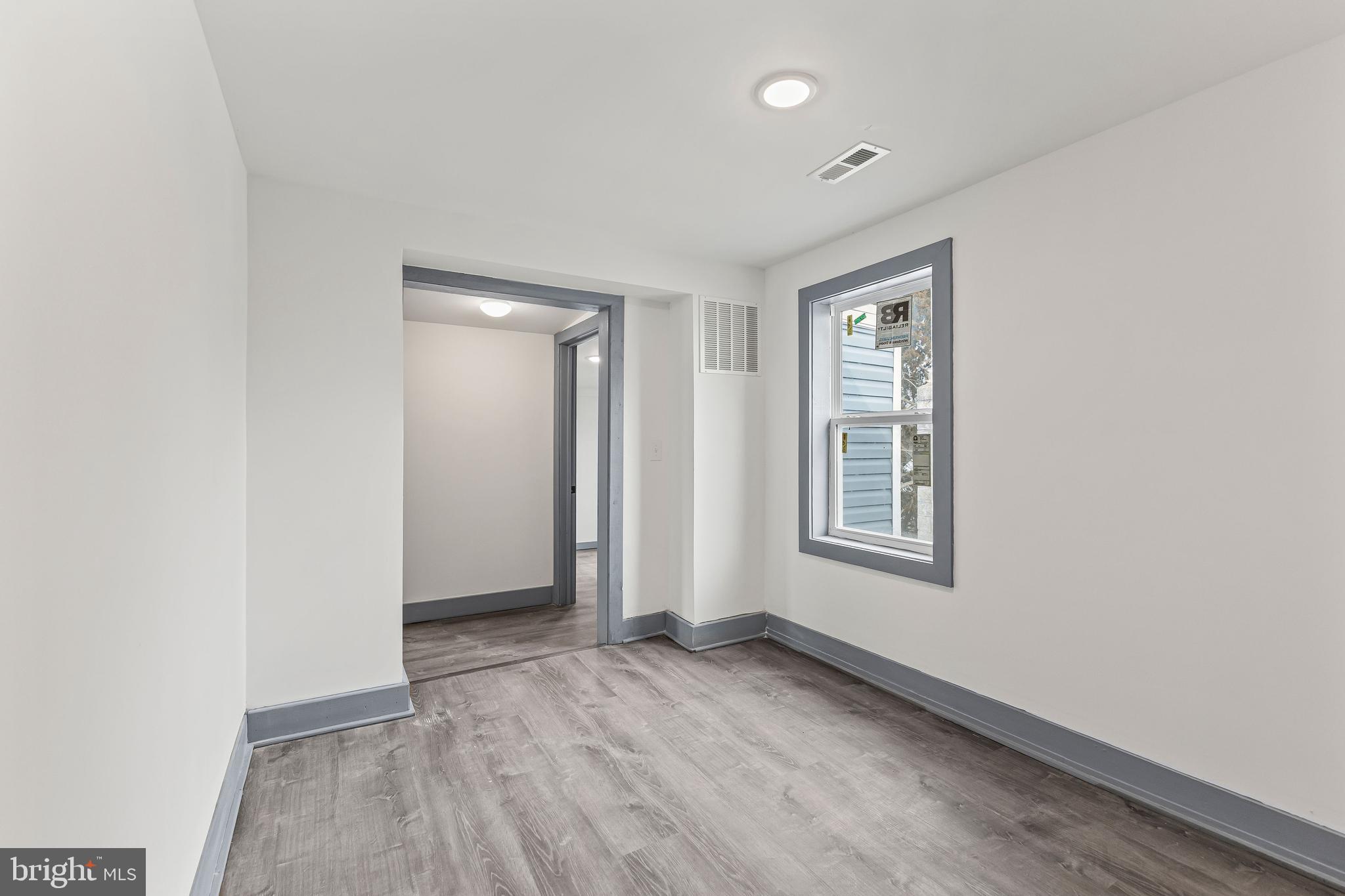 780 White Hall Road Littlestown, PA 17340 - Photo 21 of 36 an empty room with wooden floor and windows