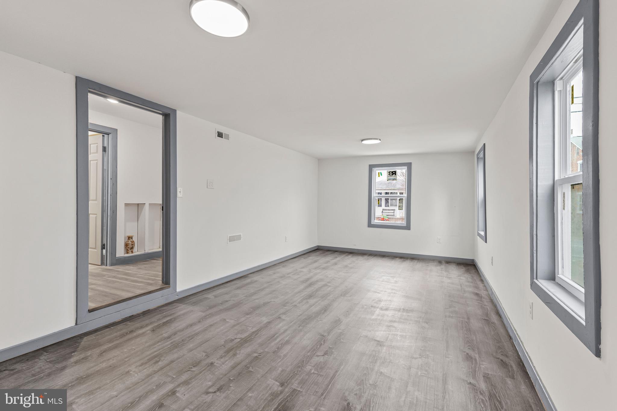 780 White Hall Road Littlestown, PA 17340 - Photo 25 of 36 an empty room with wooden floor and windows