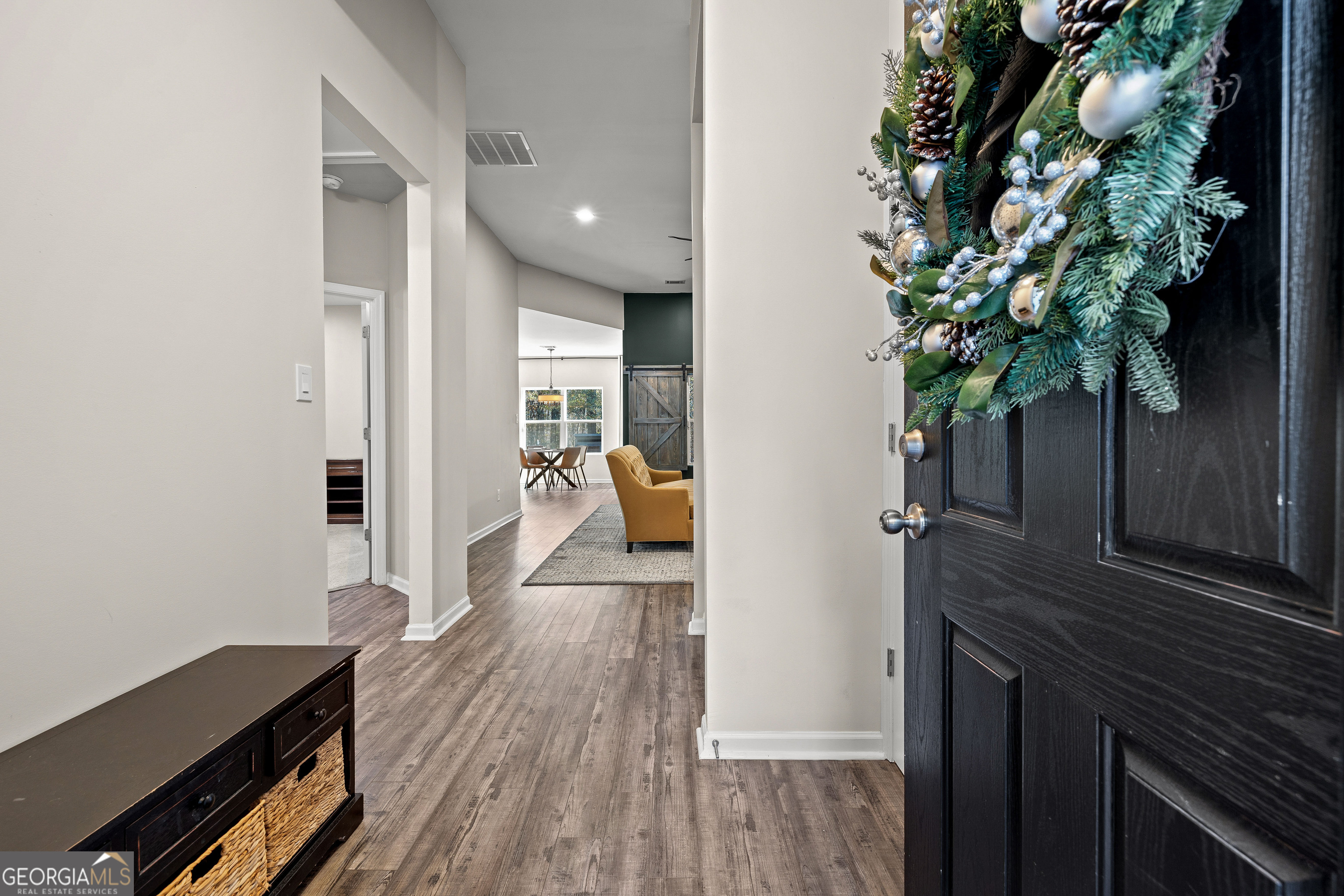 75 Homer Johnson Road Newnan, GA 30265 - Photo 12 of 51 a hallway with wooden floor and a potted plant
