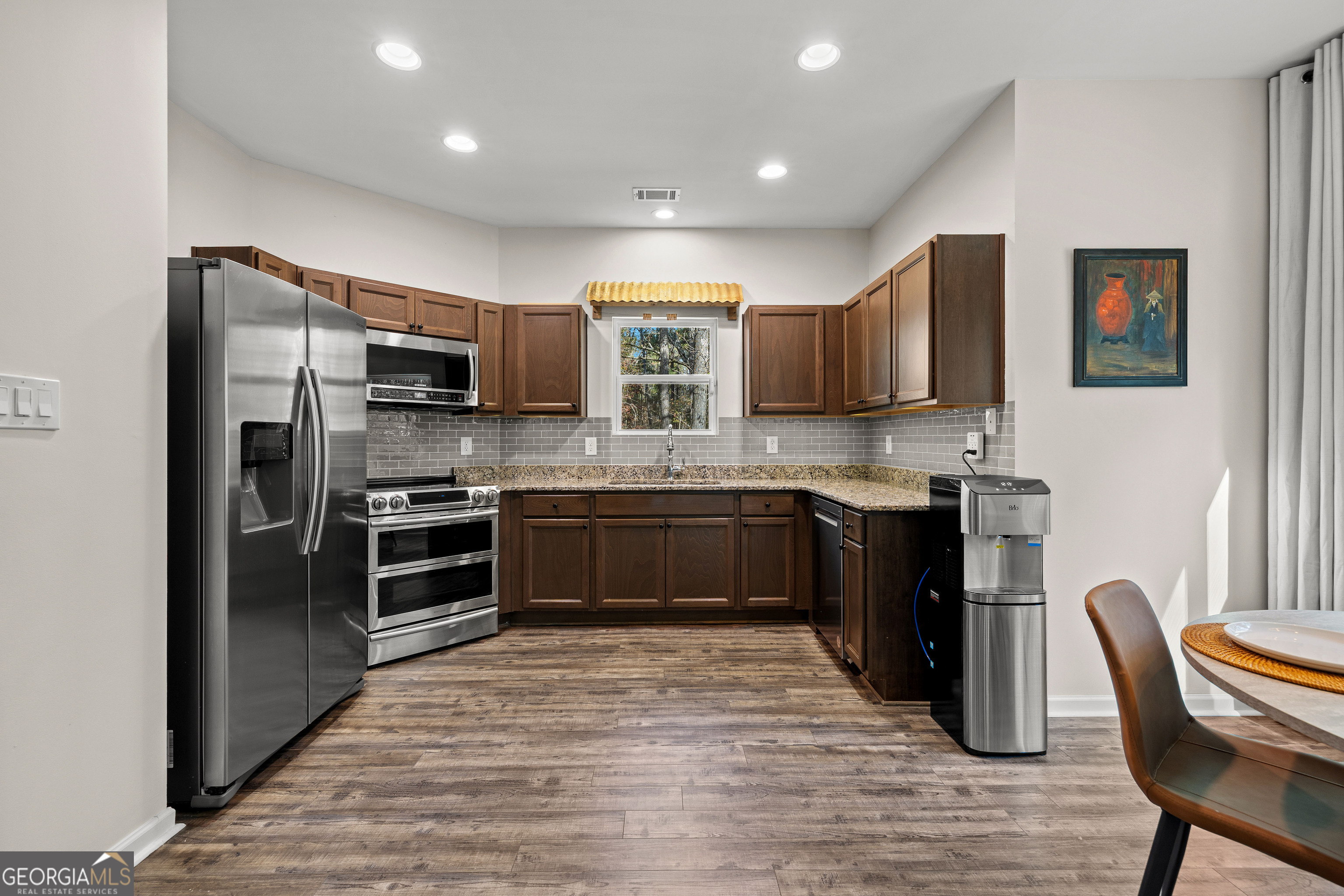 75 Homer Johnson Road Newnan, GA 30265 - Photo 17 of 51 a kitchen with stainless steel appliances and wooden cabinets