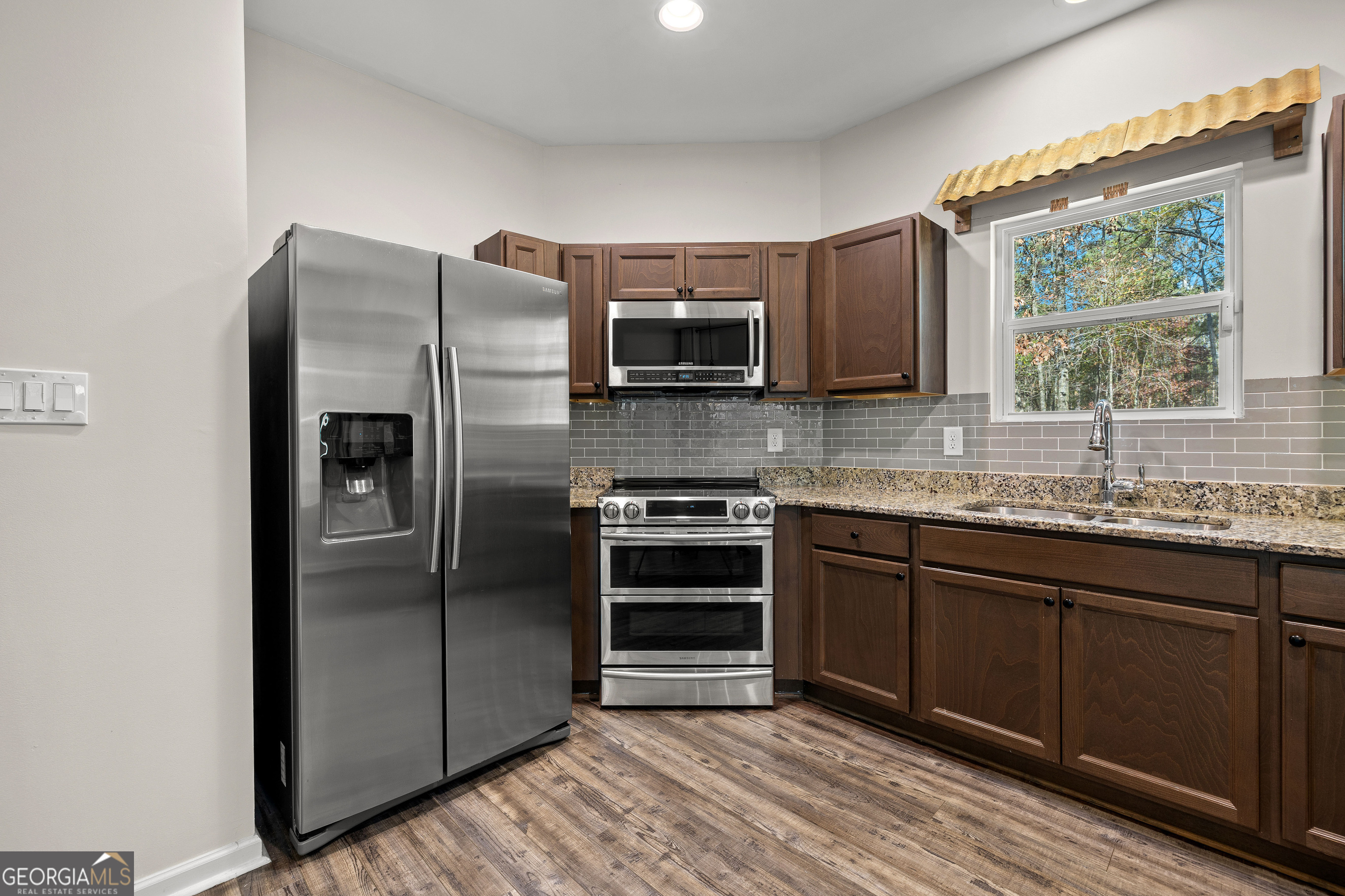 75 Homer Johnson Road Newnan, GA 30265 - Photo 18 of 51 a kitchen with stainless steel appliances granite countertop a refrigerator and a sink
