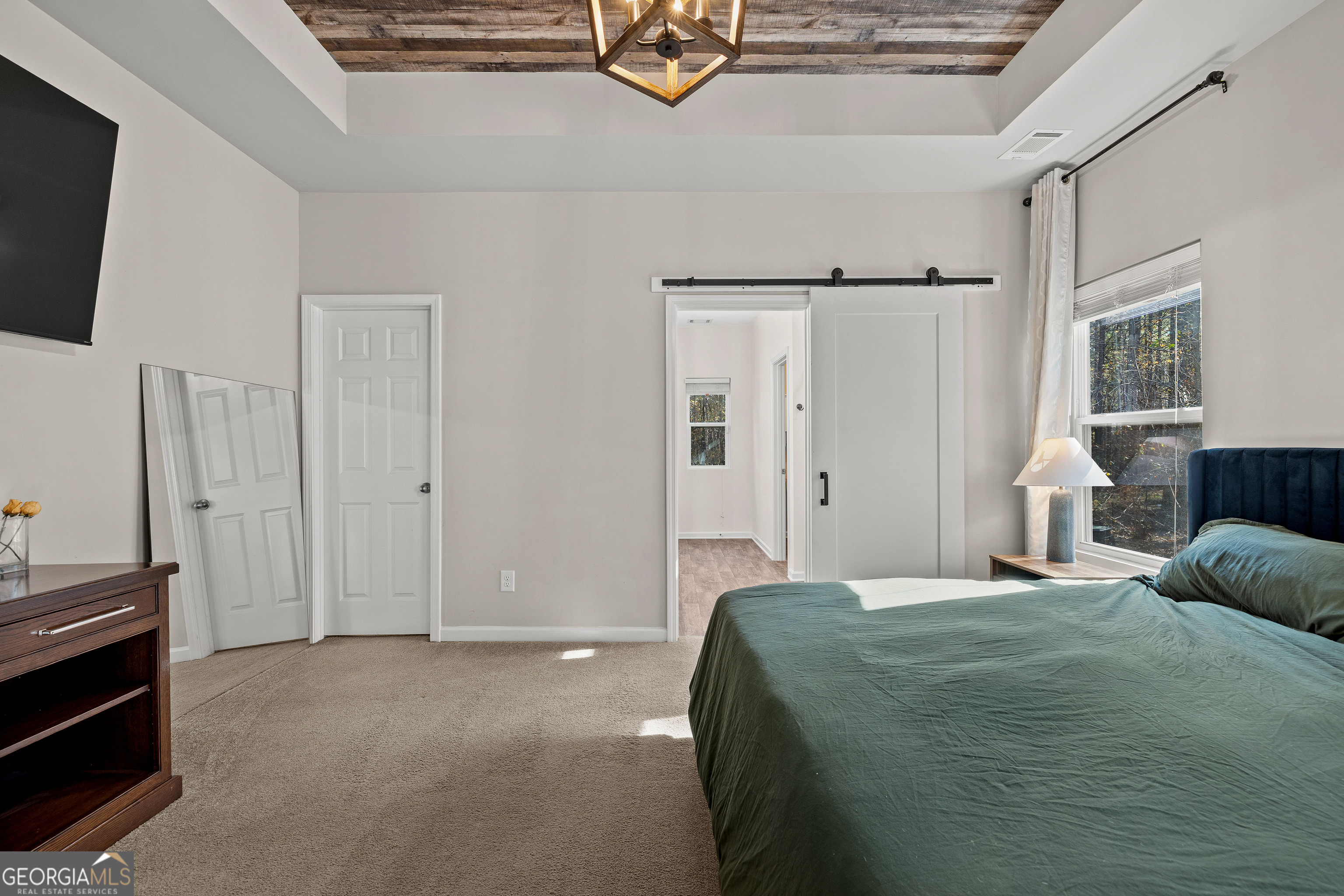 75 Homer Johnson Road Newnan, GA 30265 - Photo 23 of 51 a bedroom with a bed closet and flat tv screen