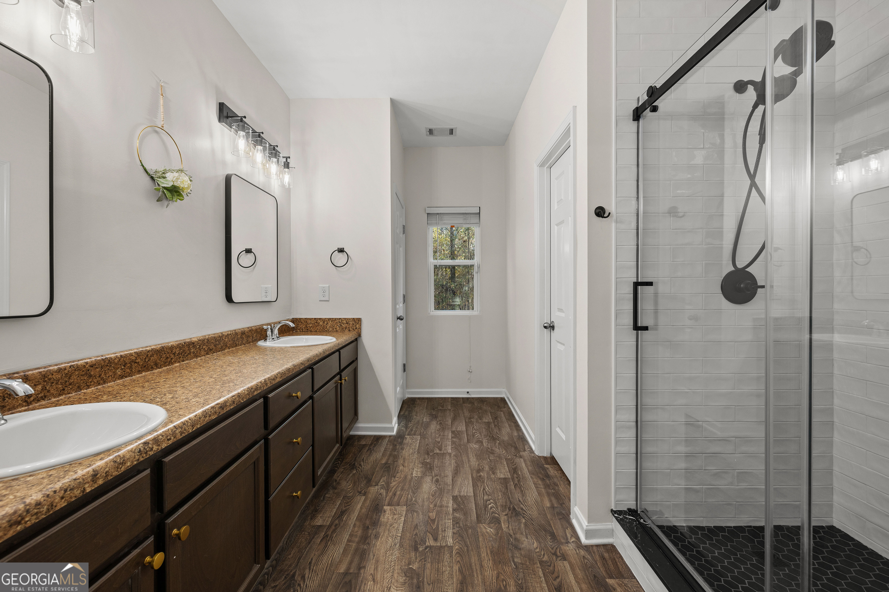 75 Homer Johnson Road Newnan, GA 30265 - Photo 24 of 51 a spacious bathroom with a granite countertop sink a mirror a vanity and a shower