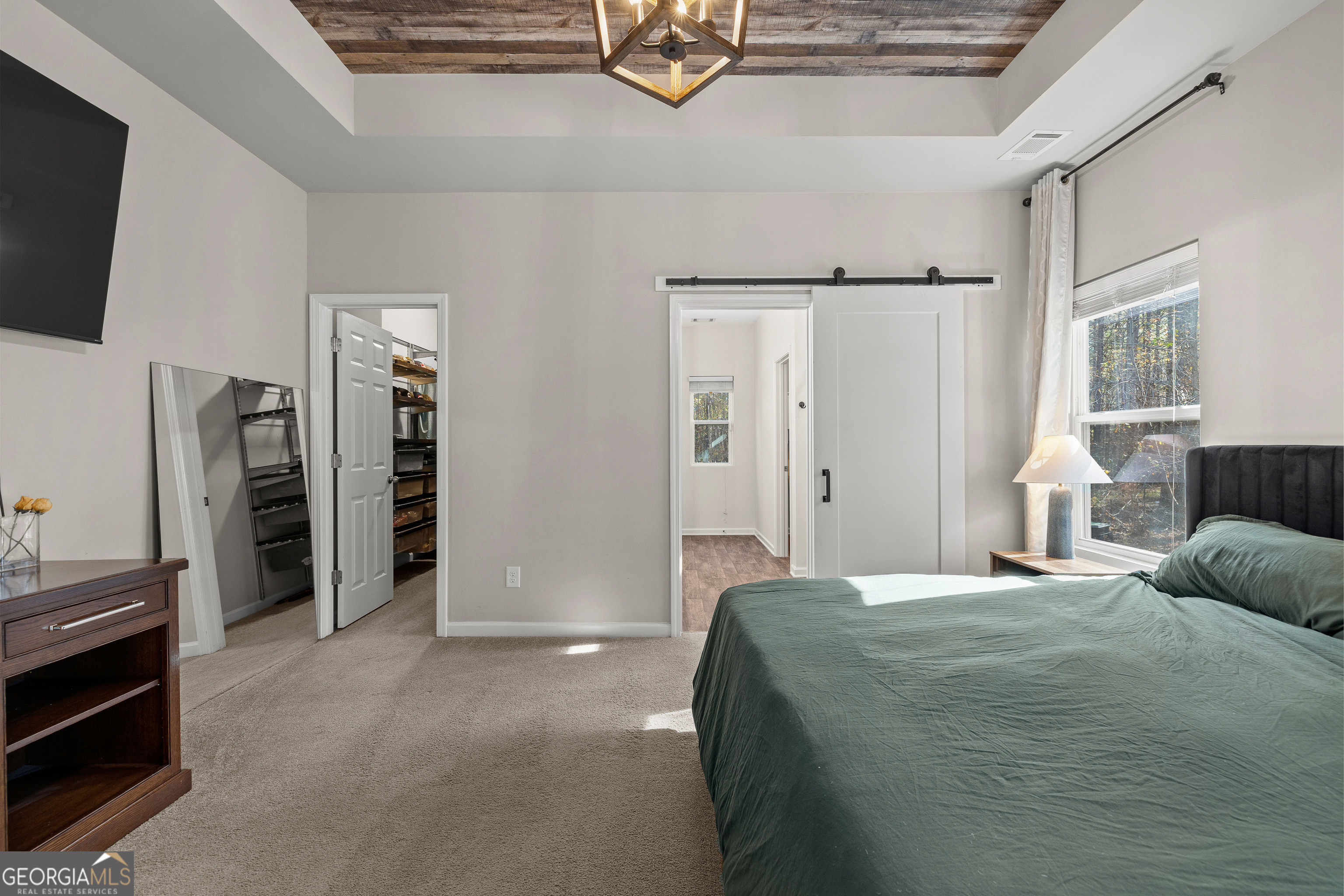 75 Homer Johnson Road Newnan, GA 30265 - Photo 28 of 51 a spacious bedroom with a bed and a flat screen tv