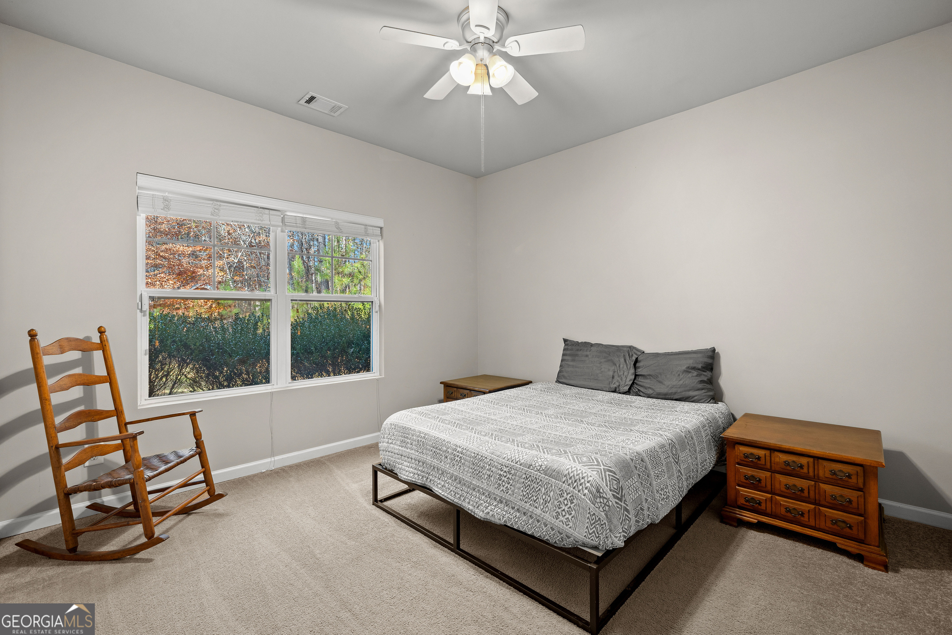 75 Homer Johnson Road Newnan, GA 30265 - Photo 31 of 51 a bedroom with a bed a lamp and a window