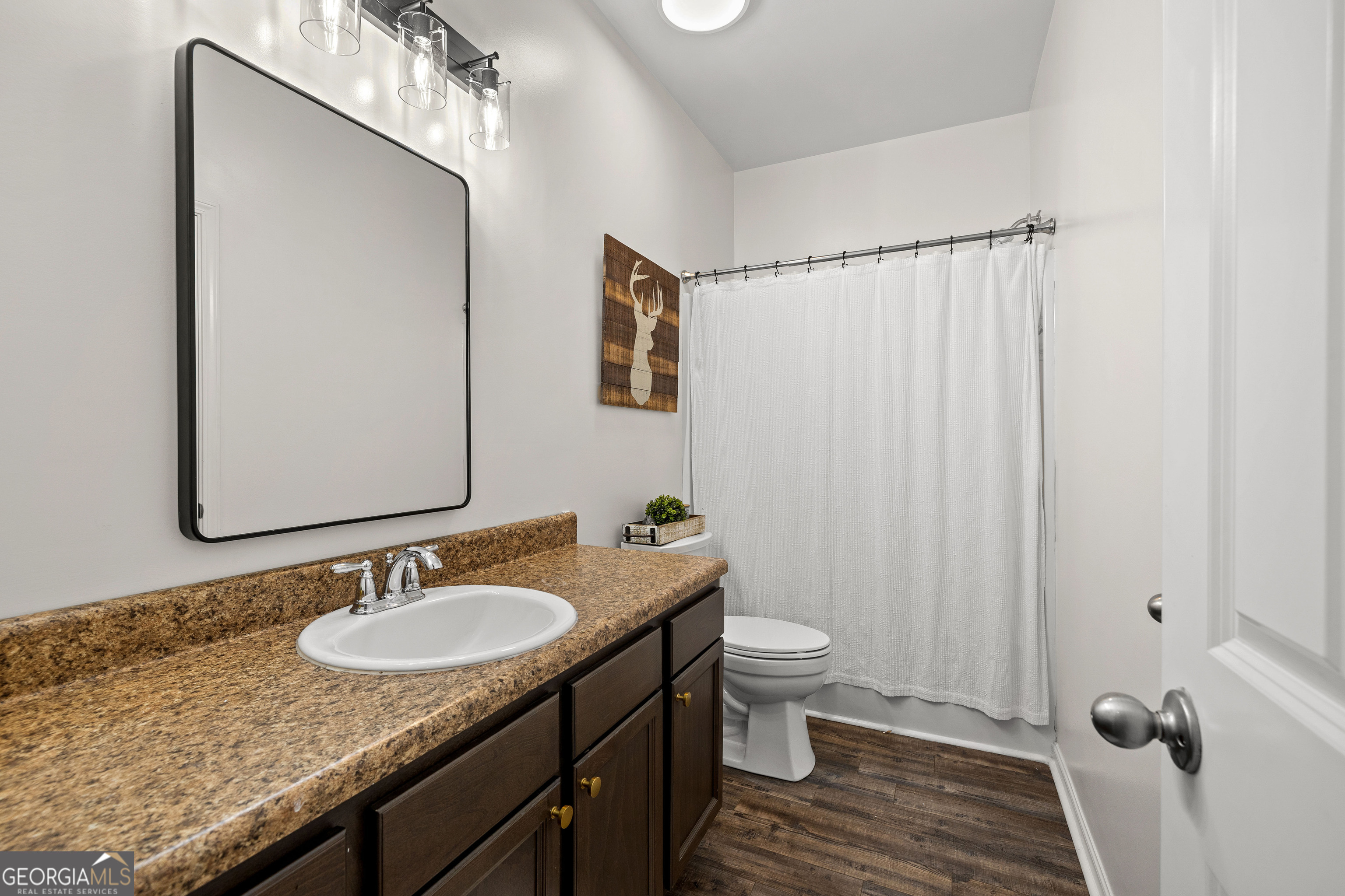 75 Homer Johnson Road Newnan, GA 30265 - Photo 34 of 51 a bathroom with a granite countertop sink toilet and shower curtains