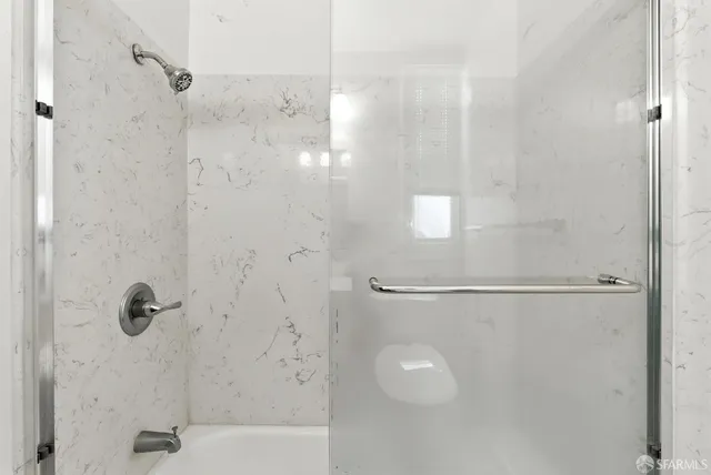 a bathroom with a shower and a shower