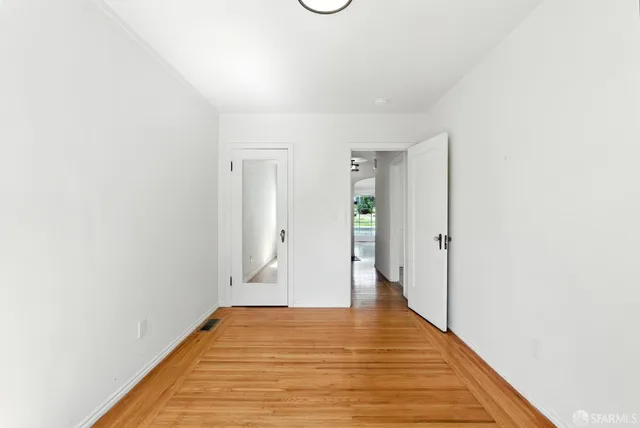 a view of a room with wooden floor and bathroom