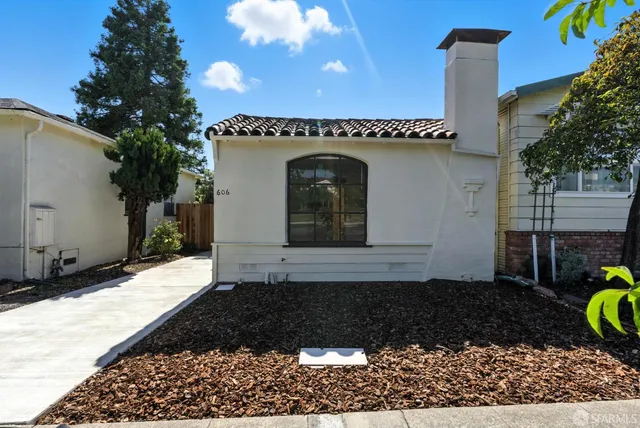 a front view of a house with a garden