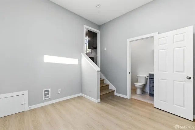 a view of an empty room with room and stairs